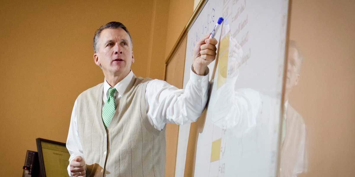 Professor Michael King pointing at the whiteboard